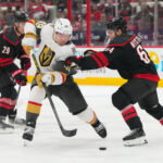 Oct 28, 2025; Raleigh, North Carolina, USA; aVegas Golden Knights left wing Ivan Barbashev (49) skates with the puck against Carolina Hurricanes defenseman Joel Nystrom (64) during the second period t Lenovo Center. Mandatory Credit: James Guillory-Imagn Images