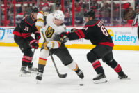 Oct 28, 2025; Raleigh, North Carolina, USA; aVegas Golden Knights left wing Ivan Barbashev (49) skates with the puck against Carolina Hurricanes defenseman Joel Nystrom (64) during the second period t Lenovo Center. Mandatory Credit: James Guillory-Imagn Images