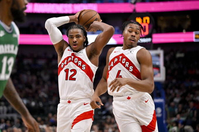 Oct 26, 2025; Dallas, Texas, USA; Toronto Raptors forward Collin Murray-Boyles (12) and forward Scottie Barnes (4) control the ball during the game between the Mavericks and the Raptors at the American Airlines Center. Mandatory Credit: Jerome Miron-Imagn Images