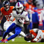 Jan 17, 2026; Denver, CO, USA; Buffalo Bills running back James Cook III (4) runs against Denver Broncos linebacker Jonah Elliss (52) and defensive end Eyioma Uwazurike (96) during the fourth quarter of an AFC Divisional Round playoff game at Empower Field at Mile High. Mandatory Credit: