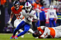 Jan 17, 2026; Denver, CO, USA; Buffalo Bills running back James Cook III (4) runs against Denver Broncos linebacker Jonah Elliss (52) and defensive end Eyioma Uwazurike (96) during the fourth quarter of an AFC Divisional Round playoff game at Empower Field at Mile High. Mandatory Credit: Ron Chenoy-Imagn Images