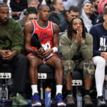 Feb 26, 2026; Inglewood, California, USA; Los Angeles Clippers forward Kawhi Leonard (left) and guard Darius Garland (second from right) watch a game from the bench during the first half against the Minnesota Timberwolves at Intuit Dome. Mandatory Credit: Kiyoshi Mio-Imagn Images