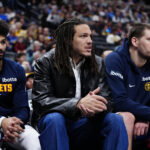 Mar 1, 2026; Denver, Colorado, USA; Denver Nuggets guard Jamal Murray (27) and forward Aaron Gordon (32) and center Nikola Jokic (15) on the bench during the second quarter against the Minnesota Timberwolves at Ball Arena. Mandatory Credit: Ron Chenoy-Imagn Images