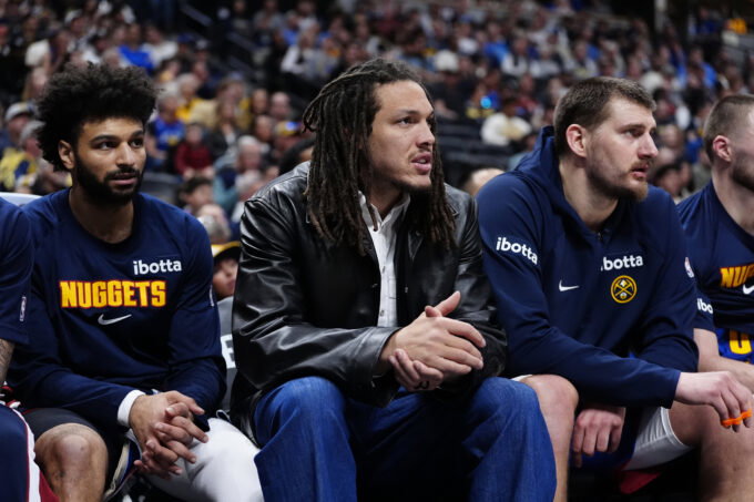 Mar 1, 2026; Denver, Colorado, USA; Denver Nuggets guard Jamal Murray (27) and forward Aaron Gordon (32) and center Nikola Jokic (15) on the bench during the second quarter against the Minnesota Timberwolves at Ball Arena. Mandatory Credit: Ron Chenoy-Imagn Images