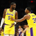 Feb 26, 2026; Phoenix, Arizona, USA; Los Angeles Lakers center Deandre Ayton (5) talks with guard Marcus Smart (36) against the Phoenix Suns at Mortgage Matchup Center. Mandatory Credit: Mark J. Rebilas-Imagn Images