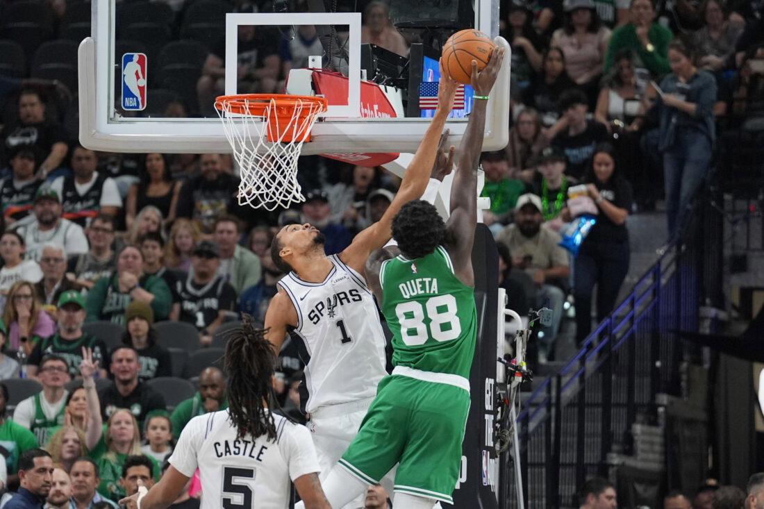 Mar 10, 2026; San Antonio, Texas, USA; San Antonio Spurs forward Victor Wembanyama (1) blocks a shot against Boston Celtics center Neemias Queta (88) in the first half at Frost Bank Center. Mandatory Credit: