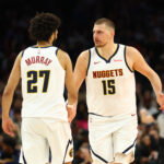 Mar 24, 2026; Phoenix, Arizona, USA; Denver Nuggets center Nikola Jokic (15) with guard Jamal Murray (27) against the Phoenix Suns in the second half at Mortgage Matchup Center. Mandatory Credit: Mark J. Rebilas-Imagn Images