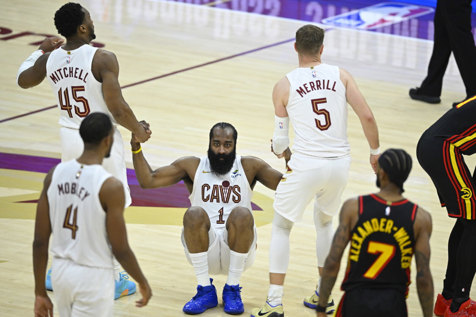 Apr 8, 2026; Cleveland, Ohio, USA; Cleveland Cavaliers guard James Harden (1) is helped to his feet by guard Donovan Mitchell (45) and guard Sam Merrill (5) in the fourth quarter against the Atlanta Hawks at Rocket Arena. Mandatory Credit: David Richard-Imagn Images