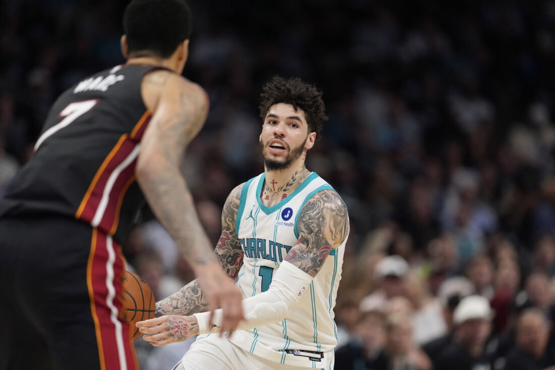 Apr 14, 2026; Charlotte, North Carolina, USA; Charlotte Hornets guard LaMelo Ball (1) handles the ball defended by Miami Heat center Kel'el Ware (7) during the second half during the play-in rounds between the Charlotte Hornets and the Miami Heat of the 2026 NBA Playoffs at Spectrum Center. Mandatory Credit: Jim Dedmon-Imagn Images