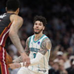 Apr 14, 2026; Charlotte, North Carolina, USA; Charlotte Hornets guard LaMelo Ball (1) handles the ball defended by Miami Heat center Kel'el Ware (7) during the second half during the play-in rounds between the Charlotte Hornets and the Miami Heat of the 2026 NBA Playoffs at Spectrum Center. Mandatory Credit: Jim Dedmon-Imagn Images