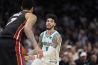 Apr 14, 2026; Charlotte, North Carolina, USA; Charlotte Hornets guard LaMelo Ball (1) handles the ball defended by Miami Heat center Kel'el Ware (7) during the second half during the play-in rounds between the Charlotte Hornets and the Miami Heat of the 2026 NBA Playoffs at Spectrum Center. Mandatory Credit: Jim Dedmon-Imagn Images