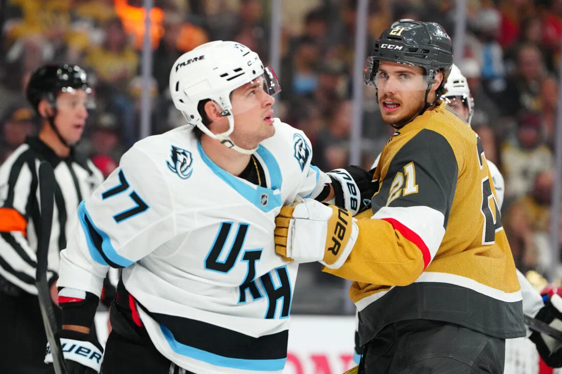 Apr 19, 2026; Las Vegas, Nevada, USA; Vegas Golden Knights center Brett Howden (21) grabs the jersey of Utah Mammoth right wing JJ Peterka (77) during the first period of game one of the first round of the 2026 Stanley Cup Playoffs at T-Mobile Arena. Mandatory Credit: Stephen R. Sylvanie-Imagn Images
