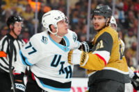 Apr 19, 2026; Las Vegas, Nevada, USA; Vegas Golden Knights center Brett Howden (21) grabs the jersey of Utah Mammoth right wing JJ Peterka (77) during the first period of game one of the first round of the 2026 Stanley Cup Playoffs at T-Mobile Arena. Mandatory Credit: Stephen R. Sylvanie-Imagn Images