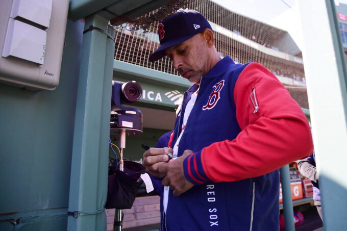 Apr 20, 2026; Boston, Massachusetts, USA; Boston Red Sox manager Alex Cora signs a baseball for a fan prior to a game against the Detroit Tigers at Fenway Park. Mandatory Credit: Bob DeChiara-Imagn Images