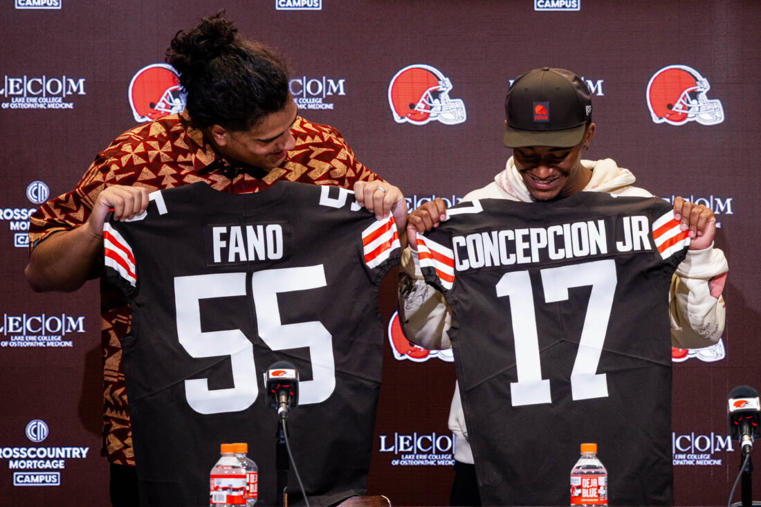 Apr 24, 2026; Berea, OH, USA; Cleveland Browns first round draft picks Spencer Fano, left, and KC Concepcion hold their new jerseys during an introductory press conference at CrossCountry Mortgage Campus.