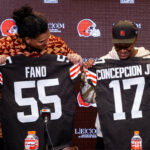 Apr 24, 2026; Berea, OH, USA; Cleveland Browns first round draft picks Spencer Fano, left, and KC Concepcion hold their new jerseys during an introductory press conference at CrossCountry Mortgage Campus.
