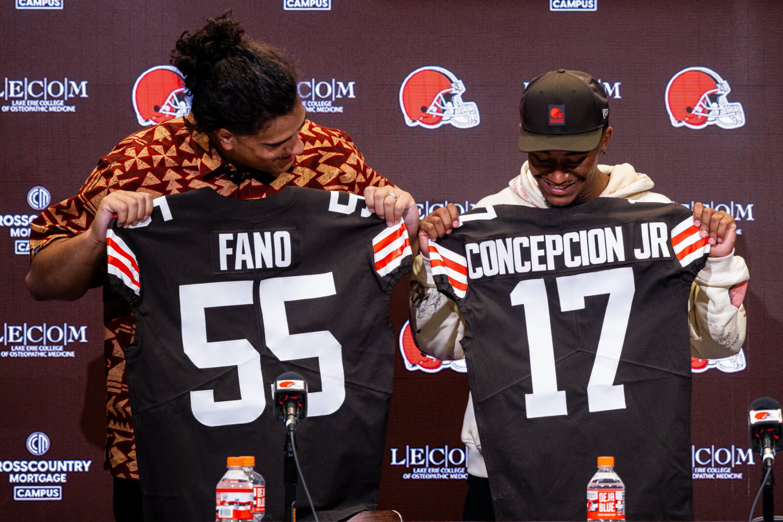 Apr 24, 2026; Berea, OH, USA; Cleveland Browns first round draft picks Spencer Fano, left, and KC Concepcion hold their new jerseys during an introductory press conference at CrossCountry Mortgage Campus.