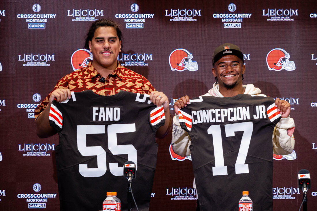 Apr 24, 2026; Berea, OH, USA; Cleveland Browns first round draft picks Spencer Fano, left, and KC Concepcion hold their new jerseys during an introductory press conference at CrossCountry Mortgage Campus. Mandatory Credit: Ken Blaze-Imagn Images