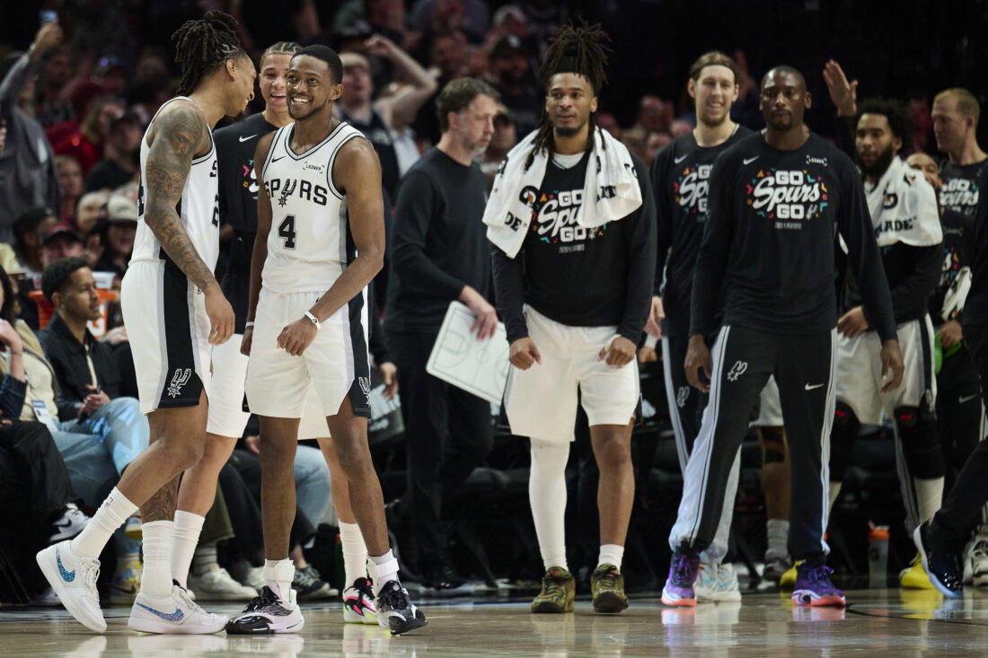 Apr 26, 2026; Portland, Oregon, USA; San Antonio Spurs guard Devin Vassell (24) and guard De'aaron Fox (4) celebrate during a break in the game during the second half against the Portland Trail Blazers during game four of the first round of the 2026 NBA Playoffs at Moda Center. Mandatory Credit: Troy Wayrynen-Imagn Images