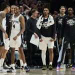 Apr 26, 2026; Portland, Oregon, USA; San Antonio Spurs guard Devin Vassell (24) and guard De'aaron Fox (4) celebrate during a break in the game during the second half against the Portland Trail Blazers during game four of the first round of the 2026 NBA Playoffs at Moda Center. Mandatory Credit: Troy Wayrynen-Imagn Images