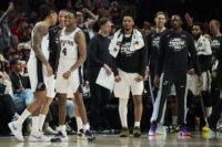 Apr 26, 2026; Portland, Oregon, USA; San Antonio Spurs guard Devin Vassell (24) and guard De'aaron Fox (4) celebrate during a break in the game during the second half against the Portland Trail Blazers during game four of the first round of the 2026 NBA Playoffs at Moda Center. Mandatory Credit: Troy Wayrynen-Imagn Images