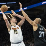 Apr 30, 2026; Minneapolis, Minnesota, USA; Denver Nuggets center Nikola Jokic (15) shoots the ball over Minnesota Timberwolves center Rudy Gobert (27) in the second half during game six of the first round of the 2026 NBA Playoffs at Target Center.