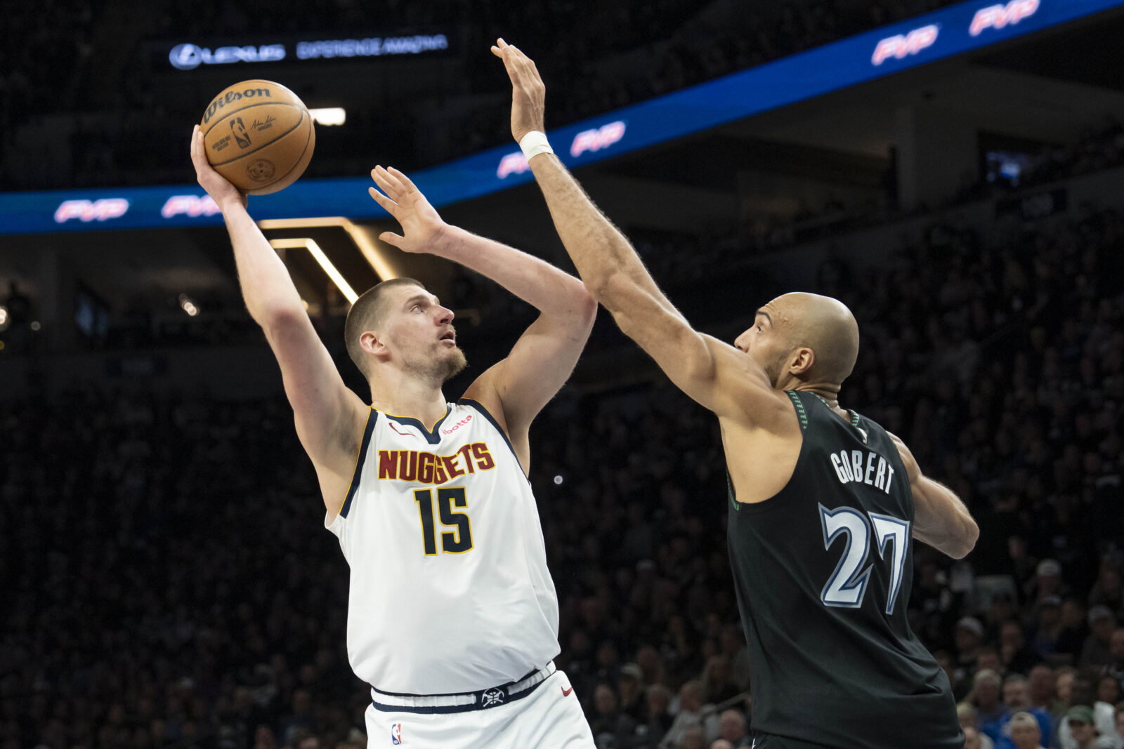 Apr 30, 2026; Minneapolis, Minnesota, USA; Denver Nuggets center Nikola Jokic (15) shoots the ball over Minnesota Timberwolves center Rudy Gobert (27) in the second half during game six of the first round of the 2026 NBA Playoffs at Target Center.