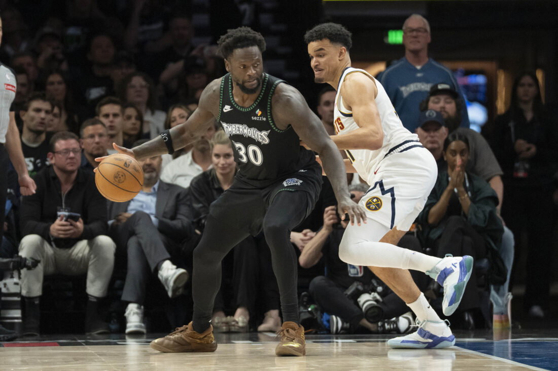 Apr 30, 2026; Minneapolis, Minnesota, USA; Minnesota Timberwolves forward Julius Randle (30) dribbles the ball as Denver Nuggets forward Spencer Jones (21) plays defense in the second half during game six of the first round of the 2026 NBA Playoffs at Target Center. Mandatory Credit: Jesse Johnson-Imagn Images