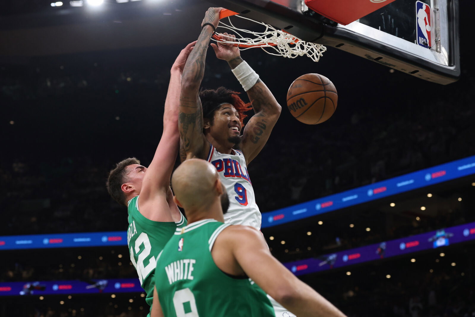 May 2, 2026; Boston, Massachusetts, USA; Philadelphia 76ers guard Kelly Oubre Jr. (9) dunks past Boston Celtics center Luka Garza (52) during the first quarter of game seven of the first round of the 2026 NBA Playoffs at TD Garden.