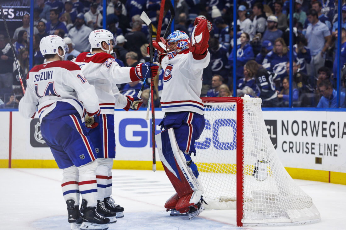 May 3, 2026; Tampa, Florida, USA; Montreal Canadiens goalie Jakub Dobes (75), defenseman Kaiden Guhle (21) and forward Nick Suzuki (14) react to beating the Tampa Bay Lightning in game seven of the first round of the 2026 Stanley Cup Playoffs at Benchmark International Arena.