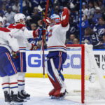 May 3, 2026; Tampa, Florida, USA; Montreal Canadiens goalie Jakub Dobes (75), defenseman Kaiden Guhle (21) and forward Nick Suzuki (14) react to beating the Tampa Bay Lightning in game seven of the first round of the 2026 Stanley Cup Playoffs at Benchmark International Arena.