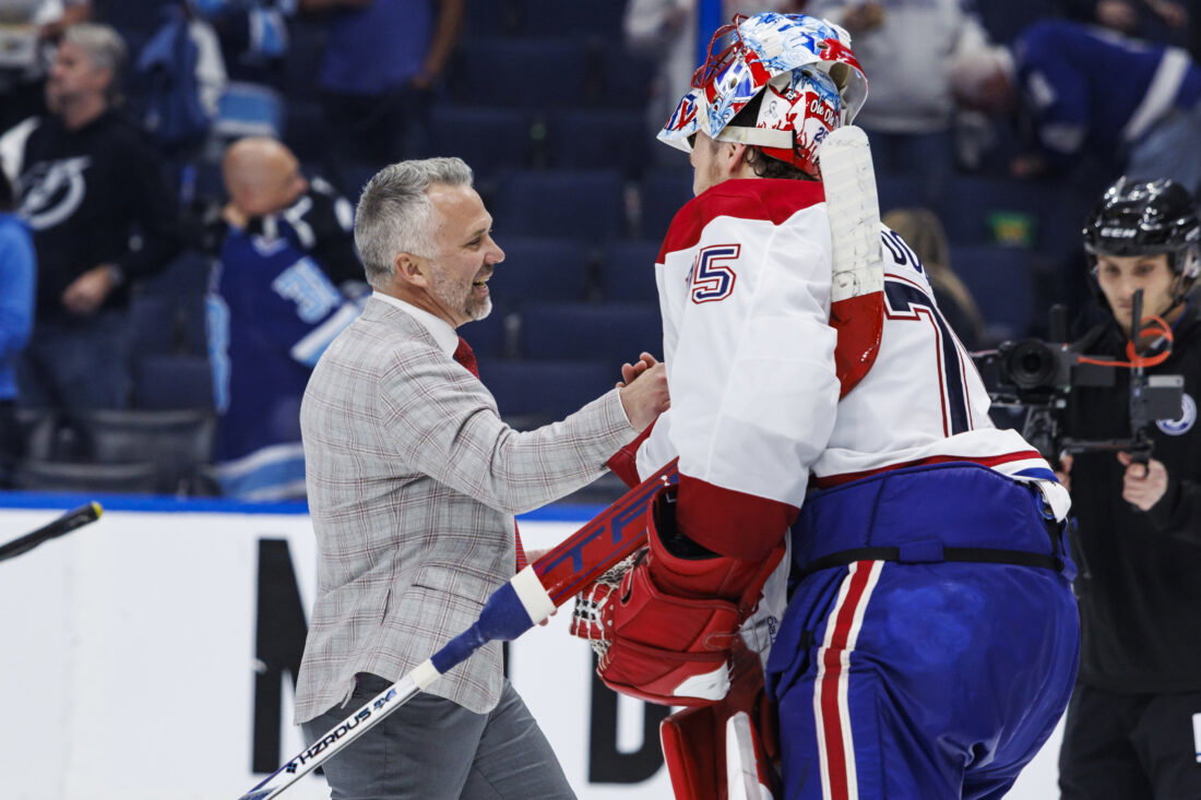 May 3, 2026; Tampa, Florida, USA; the Montreal Canadiens head coach Martin St. Louis and goalie Jakub Dobes (75) react to beating the Tampa Bay Lightning in game seven of the first round of the 2026 Stanley Cup Playoffs at Benchmark International Arena. Mandatory Credit: Morgan Tencza-Imagn Images