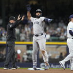 May 9, 2026; Milwaukee, Wisconsin, USA; New York Yankees third baseman Amed Rosario (14) signals back to the dug out after hitting a double against the Milwaukee Brewers in the ffourth inning at American Family Field. Mandatory Credit: Michael McLoone-Imagn Images