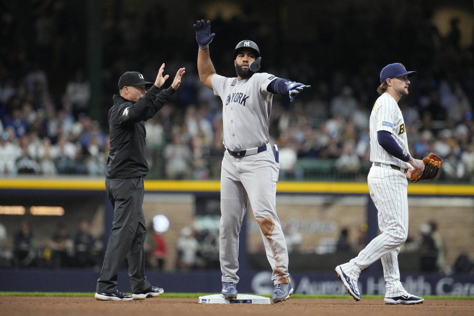 May 9, 2026; Milwaukee, Wisconsin, USA; New York Yankees third baseman Amed Rosario (14) signals back to the dug out after hitting a double against the Milwaukee Brewers in the ffourth inning at American Family Field. Mandatory Credit: Michael McLoone-Imagn Images