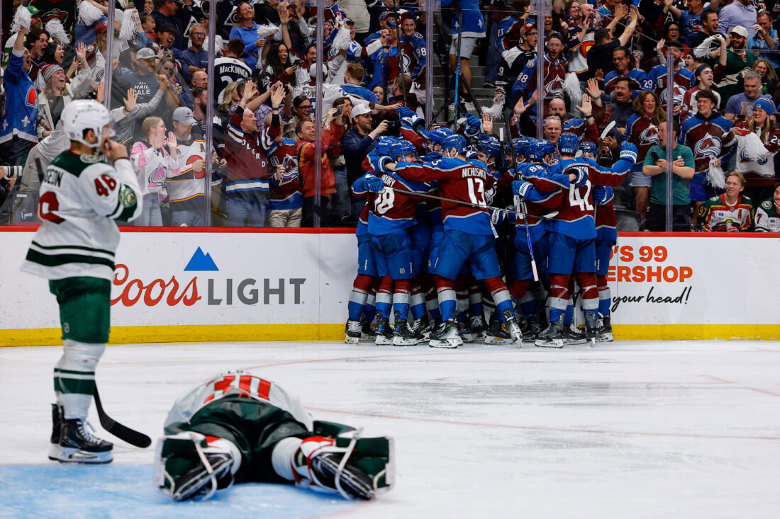 May 13, 2026; Denver, Colorado, USA; Colorado Avalanche players celebrate after the game as Minnesota Wild goaltender Jesper Wallstedt (30) lies on the ice next to defenseman Jared Spurgeon (46) in game five of the second round of the 2026 Stanely Cup Playoffs at Ball Arena. Mandatory Credit: Isaiah J. Downing-Imagn Images