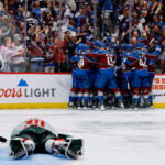 May 13, 2026; Denver, Colorado, USA; Colorado Avalanche players celebrate after the game as Minnesota Wild goaltender Jesper Wallstedt (30) lies on the ice next to defenseman Jared Spurgeon (46) in game five of the second round of the 2026 Stanely Cup Playoffs at Ball Arena. Mandatory Credit: Isaiah J. Downing-Imagn Images