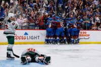 May 13, 2026; Denver, Colorado, USA; Colorado Avalanche players celebrate after the game as Minnesota Wild goaltender Jesper Wallstedt (30) lies on the ice next to defenseman Jared Spurgeon (46) in game five of the second round of the 2026 Stanely Cup Playoffs at Ball Arena. Mandatory Credit: Isaiah J. Downing-Imagn Images