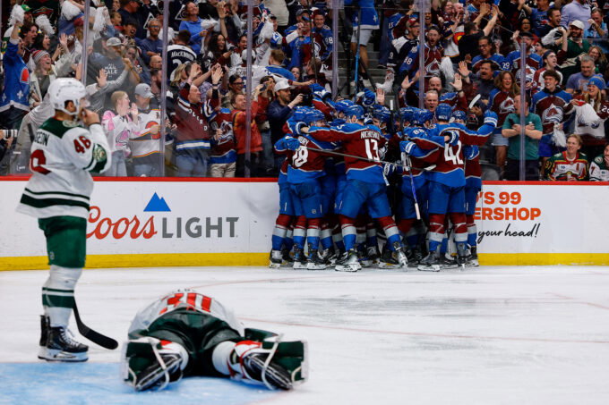 May 13, 2026; Denver, Colorado, USA; Colorado Avalanche players celebrate after the game as Minnesota Wild goaltender Jesper Wallstedt (30) lies on the ice next to defenseman Jared Spurgeon (46) in game five of the second round of the 2026 Stanely Cup Playoffs at Ball Arena. Mandatory Credit: Isaiah J. Downing-Imagn Images