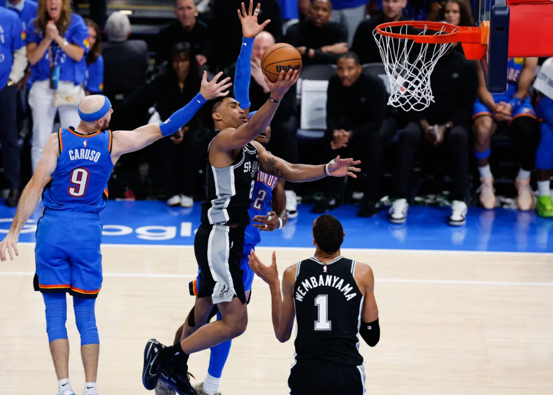May 18, 2026; Oklahoma City, Oklahoma, USA; San Antonio Spurs guard Dylan Harper (2) shoots while defined by Oklahoma City Thunder guard Alex Caruso (9) in overtime during game one of the western conference finals for the 2026 NBA playoffs at Paycom Center. Mandatory Credit: Alonzo Adams-Imagn Images