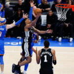 May 18, 2026; Oklahoma City, Oklahoma, USA; San Antonio Spurs guard Dylan Harper (2) shoots while defined by Oklahoma City Thunder guard Alex Caruso (9) in overtime during game one of the western conference finals for the 2026 NBA playoffs at Paycom Center. Mandatory Credit: Alonzo Adams-Imagn Images