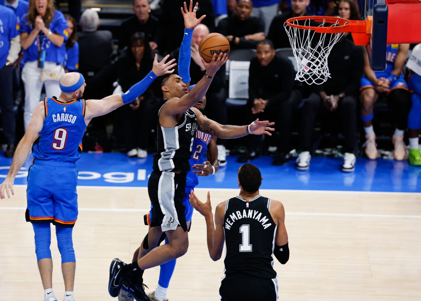 May 18, 2026; Oklahoma City, Oklahoma, USA; San Antonio Spurs guard Dylan Harper (2) shoots while defined by Oklahoma City Thunder guard Alex Caruso (9) in overtime during game one of the western conference finals for the 2026 NBA playoffs at Paycom Center. Mandatory Credit: Alonzo Adams-Imagn Images