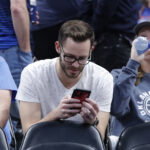 Oklahoma City, Oklahoma, USA; A fan looks at his phone during the Oklahoma City Thunder's regular season game against the Utah Jazz. Mandatory Credit: Alonzo Adams-USA TODAY Sports