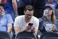 Oklahoma City, Oklahoma, USA; A fan looks at his phone during the Oklahoma City Thunder's regular season game against the Utah Jazz. Mandatory Credit: Alonzo Adams-USA TODAY Sports