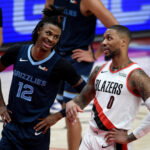Apr 25, 2021; Portland, Oregon, USA; Memphis Grizzlies guard Ja Morant (12) and Portland Trail Blazers guard Damian Lillard (0) share a moment during the second half of the game at Moda Center. The Grizzlies won 120-113. Mandatory Credit: Steve Dykes-USA TODAY Sports