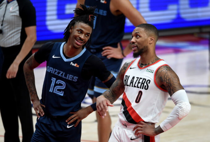 Apr 25, 2021; Portland, Oregon, USA; Memphis Grizzlies guard Ja Morant (12) and Portland Trail Blazers guard Damian Lillard (0) share a moment during the second half of the game at Moda Center. The Grizzlies won 120-113. Mandatory Credit: Steve Dykes-USA TODAY Sports