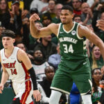 Oct 30, 2023; Milwaukee, Wisconsin, USA; Milwaukee Bucks forward Giannis Antetokounmpo (34) reacts after scoring a basket as Miami Heat guard Tyler Herro (14) looks on in the fourth quarter at Fiserv Forum. Mandatory Credit: Benny Sieu-USA TODAY Sports