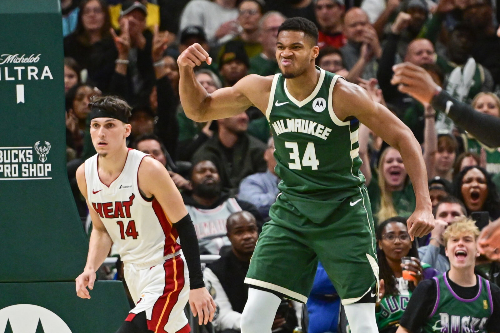 Oct 30, 2023; Milwaukee, Wisconsin, USA; Milwaukee Bucks forward Giannis Antetokounmpo (34) reacts after scoring a basket as Miami Heat guard Tyler Herro (14) looks on in the fourth quarter at Fiserv Forum. Mandatory Credit: Benny Sieu-USA TODAY Sports