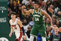 Oct 30, 2023; Milwaukee, Wisconsin, USA; Milwaukee Bucks forward Giannis Antetokounmpo (34) reacts after scoring a basket as Miami Heat guard Tyler Herro (14) looks on in the fourth quarter at Fiserv Forum. Mandatory Credit: Benny Sieu-USA TODAY Sports