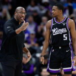 Jan 3, 2024; Sacramento, California, USA; Sacramento Kings head coach Mike Brown talks with guard De'Aaron Fox (5) during the third quarter against the Orlando Magic at Golden 1 Center. Mandatory Credit: Sergio Estrada-USA TODAY Sports