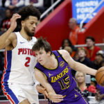 Nov 4, 2024; Detroit, Michigan, USA; Los Angeles Lakers guard Austin Reaves (15) dribbles defended by Detroit Pistons guard Cade Cunningham (2) in the first half at Little Caesars Arena. Mandatory Credit: Rick Osentoski-Imagn Images